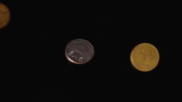 Thailändische Und Indonesische Münzen Fallen Zeitlupe Vor Einen Schwarzen Spiegelhintergrund — Stockvideo