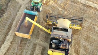 Harvester in harvest time in a wheat field. Navarre, Spain, Europe. Aerial view. 4K.
