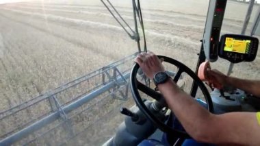 Combine harvester working in harvest time in a wheat field. View from cab. Navarre, Spain, Europe. 4K.