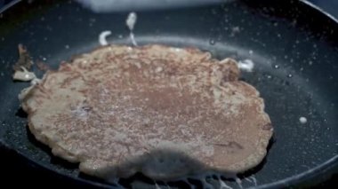 making buckwheat pancakes in the pan. close-up. 4K.