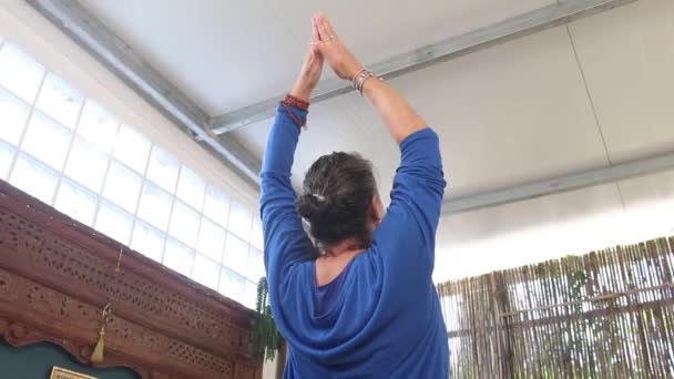 身穿蓝色衣服的瑜伽老师在学生面前做伸展运动 — 图库视频影像
