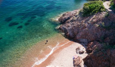 One person in Aiguille beach in Theoule sur Mer on the French Riviera