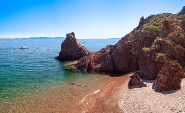 Sailboat on the Mediterranean sea and Aiguille beach in Theoule sur Mer on the French Riviera