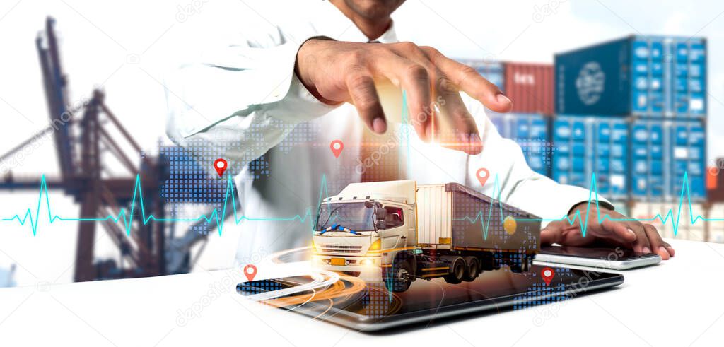 Businessman employing tablet for logistic network distribution and smart transportation, networking intelligent logistics of truck and container cargo ship, logistic import export, and industrial.