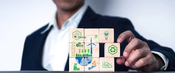 The idea of net zero activity. Energy conservation, green energy, carbon reduction, carbon capture Long-term climate neutral plan Reduce global warming. Use green paint on wooden cubes net zero symbol