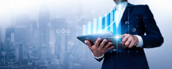 A businessman looks over sales figures and a 3D graph of economic growth. This is a business plan. The abstract icon. The usage of digital marketing is referred to as