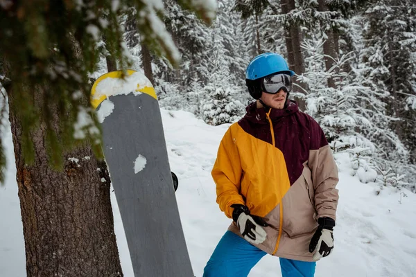 Desporto de inverno e recreação, lazer atividades ao ar livre. Homem de equipamento de esqui, com óculos de segurança. Homem de snowboarder caminhadas na montanha — Fotografia de Stock