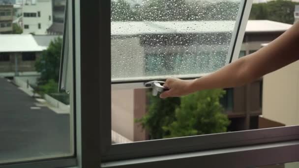 Woman Hand Closes Condo Window Raindrops Glass — Vídeo de Stock