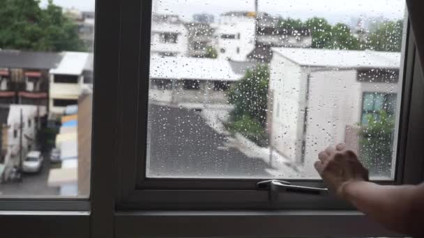 Woman Opening Window Rain City Houses Background — Video Stock