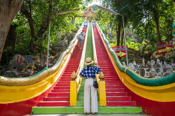 Kanchanaburi, Tayland-23 Ekim 2022: Turistler Wat Tham Seua 'daki parlak renkli merdivenlerden inip çıkıyorlar.