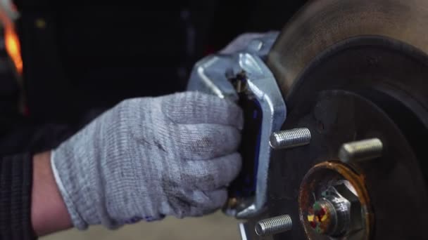 The car mechanic unscrews the brake pads. Close-up — Stock Video