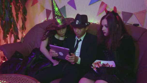 Un gruppo di amici sta guardando un inquietante film di Halloween su un tablet. Paura — Video Stock