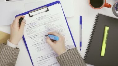 Bilgisayarda çalışan bir iş kadınının en iyi görüntüsü ve bir masada kağıt üzerine işaretle notlar alması.