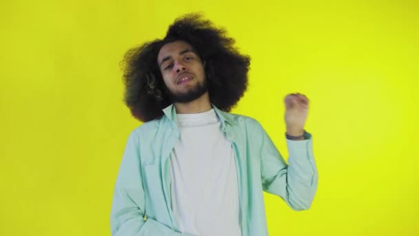 Blah, Blah, Blah. A bored African-American, gesturing with a Blah-Blah gesture, tired of conversations and uninteresting information, posing on a yellow background — Stock Video