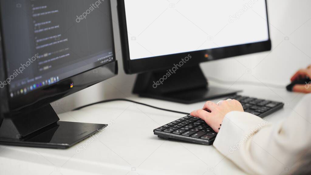 Scrolling the HTML web page code. Young female programmer