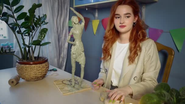 Krásná rusovlasá dívka vytesává plastikovou sochu. Ruční práce — Stock video