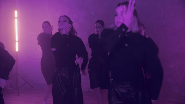 A group of beautiful girls dancing indoors in black suits. Dances — Zdjęcie stockowe