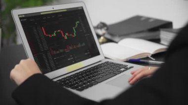 Bitcoin işlem istatistiklerinin bir grafiğinin görülebildiği laptop ekranının yakın çekimi. Bir iş adamı.
