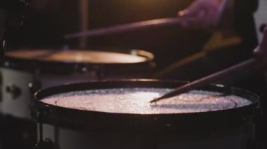 Ağır çekimde davul sineğine çarpan su damlaları. Davulcu çalar ve çalar