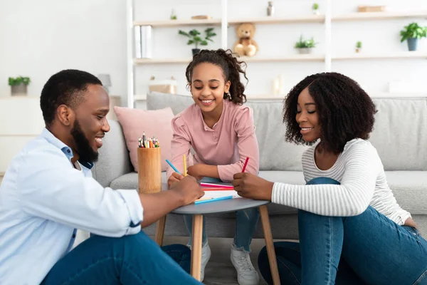 Portrait of happy black family drawing picture together — Stock Photo, Image