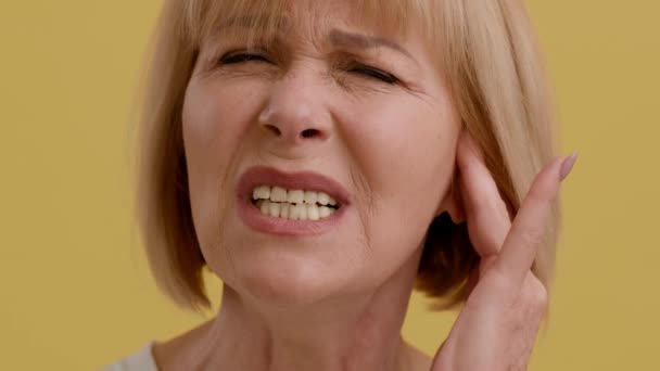 Dor nos ouvidos. Mulher Sênior doente que sofre de dor de ouvido, tendo otite doença — Vídeo de Stock