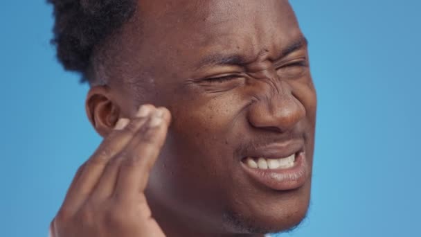 Earache. Close up portrait of young african american man suffering from ear pain, suffering from otitis disease — Stock Video