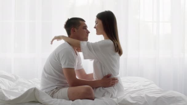 Portrait Of Romantic Young Couple Embracing In Bed In The Morning — Stock Video