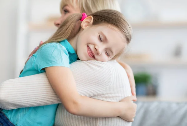 Happy mature woman embracing her granddaughter, closeup — Stock Photo, Image