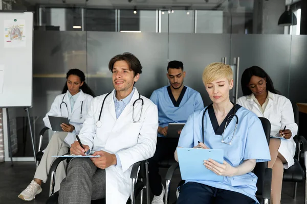 Multiethnic group of doctors attending medical training at clinic