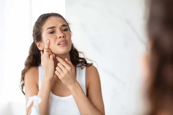 Desperate Lady Squeezing Pimple On Face Near Mirror In Bathroom — Stock Photo, Image