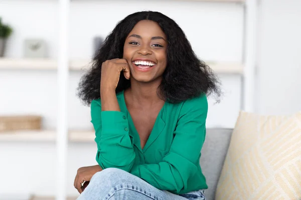 Cheerful attractive black lady posing at home — Stock Photo, Image