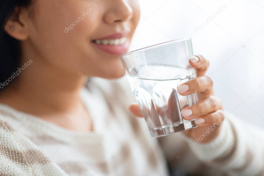 Hydration Concept. Closeup Shot Of Smiling Young Lady Drinking Water From Glass