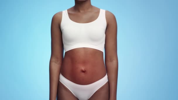 Female health problems. Studio shot of unrecognizable black woman wearing underwear with red pulsating stomach — Stock Video