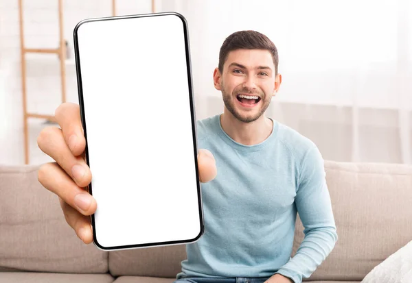 Προσφορά κινητού. Χαρούμενος νεαρός άνδρας που επιδεικνύει κενή άσπρη οθόνη Smartphone στην κάμερα — Φωτογραφία Αρχείου