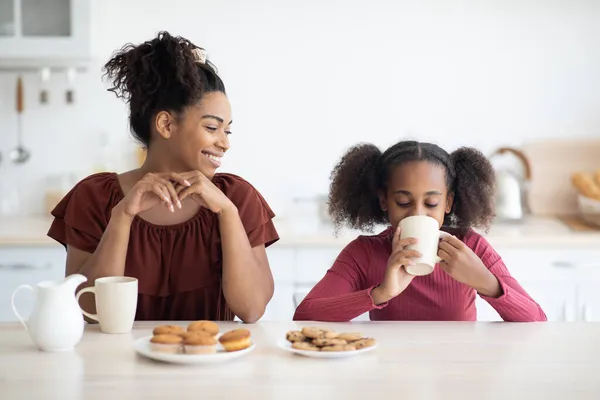 Bela mãe negra e filha desfrutando de pastelaria fresca — Fotografia de Stock
