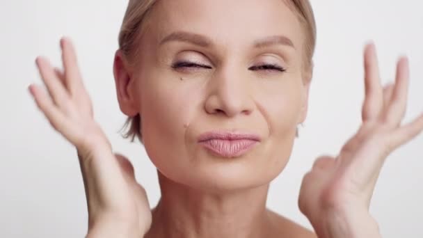 Face Lifting Concept. Beautiful Middle Aged Woman Making Revitalizing Facial Massage — Stock Video