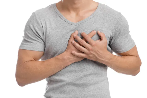 Cropped millennial european muscular male suffering from chest pain, presses hand to sore spot — Stock Photo, Image