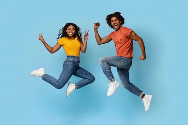 Carefree african american couple fooling on blue — Stock Photo, Image
