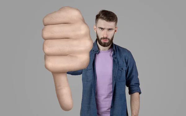 Angry bearded young man showing thumb down — Stock Photo, Image