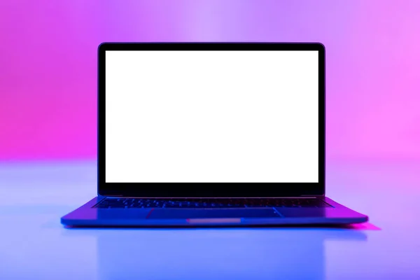 Laptop computer with blank white screen in neon light, mockup for desktop or website — Stock Photo, Image
