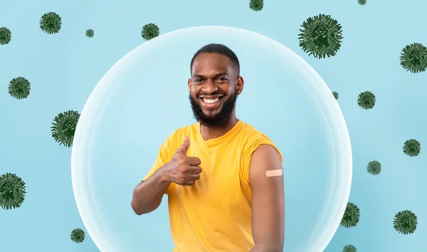Jovem americano africano alegre mostrar ombro com gesso após a vacinação e polegar para cima — Fotografia de Stock