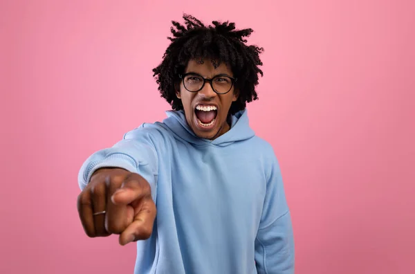 Angry black teenager shouting and pointing at camera on pink studio background. Negative emotions concept — Stock Photo, Image