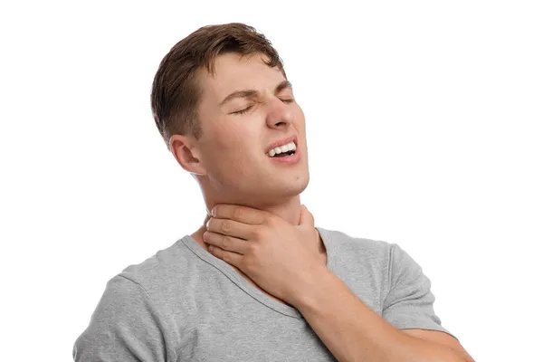 Upset attractive young european guy suffer from sore throat and pressing hand to sore spot, with painful expression — Stock Photo, Image