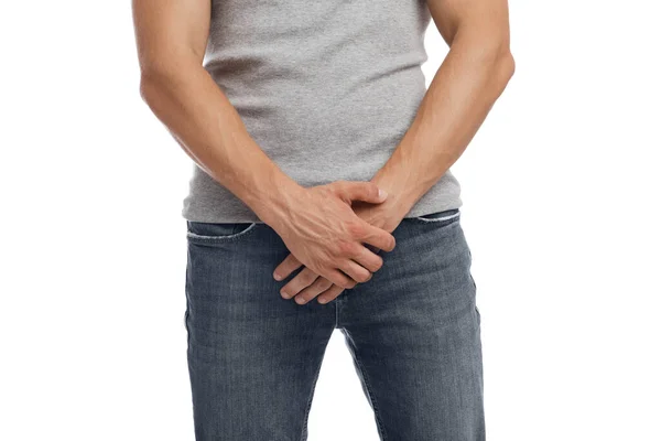 Unrecognizable millennial european guy suffering from health problems and pressing hands to groin — Stock Photo, Image