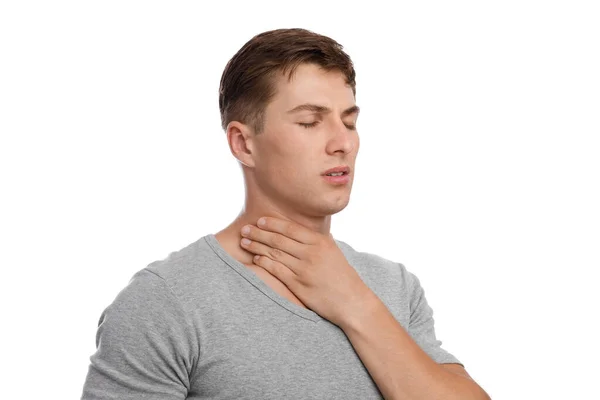 Upset handsome young european guy suffering from sore throat, feeling unwell, isolated on white background — Stock Photo, Image