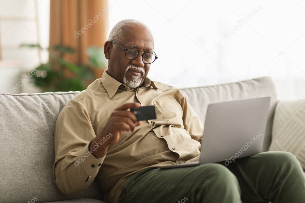 Senior African American Man Shopping Online Using Laptop At Home