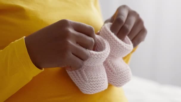 黑色怀孕妇女带着小宝宝鞋轻松愉快地踩在她的美女身上 — 图库视频影像