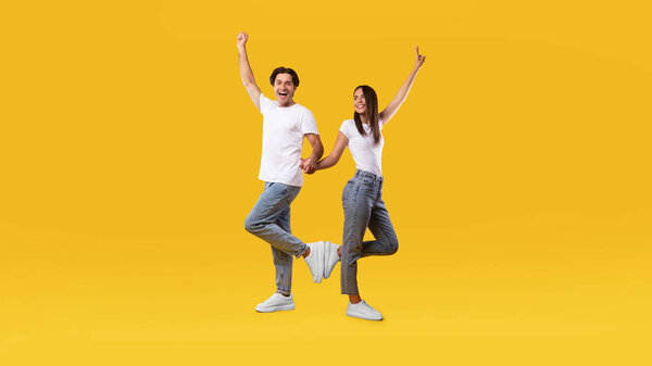 Portrait of excited young couple celebrating victory