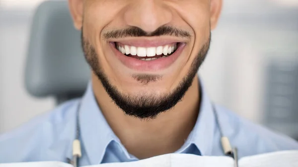 Fogászati kezelés eredménye. Boldog fiatal arab férfi mosolygó tökéletes fogak, közelről — Stock Fotó