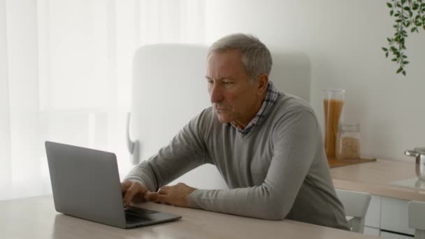 Remote Work On Retirement. Focused Senior Man Working With Laptop At Home — Stock Video